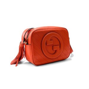 Gucci Soho Disco Bag in vibrant orange leather with gold-tone hardware and leather tassel.